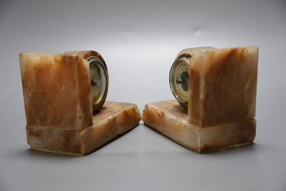 A pair of 1930s marble book-ends, one incorporates an aneroid barometer, the other a timepiece, 11cm